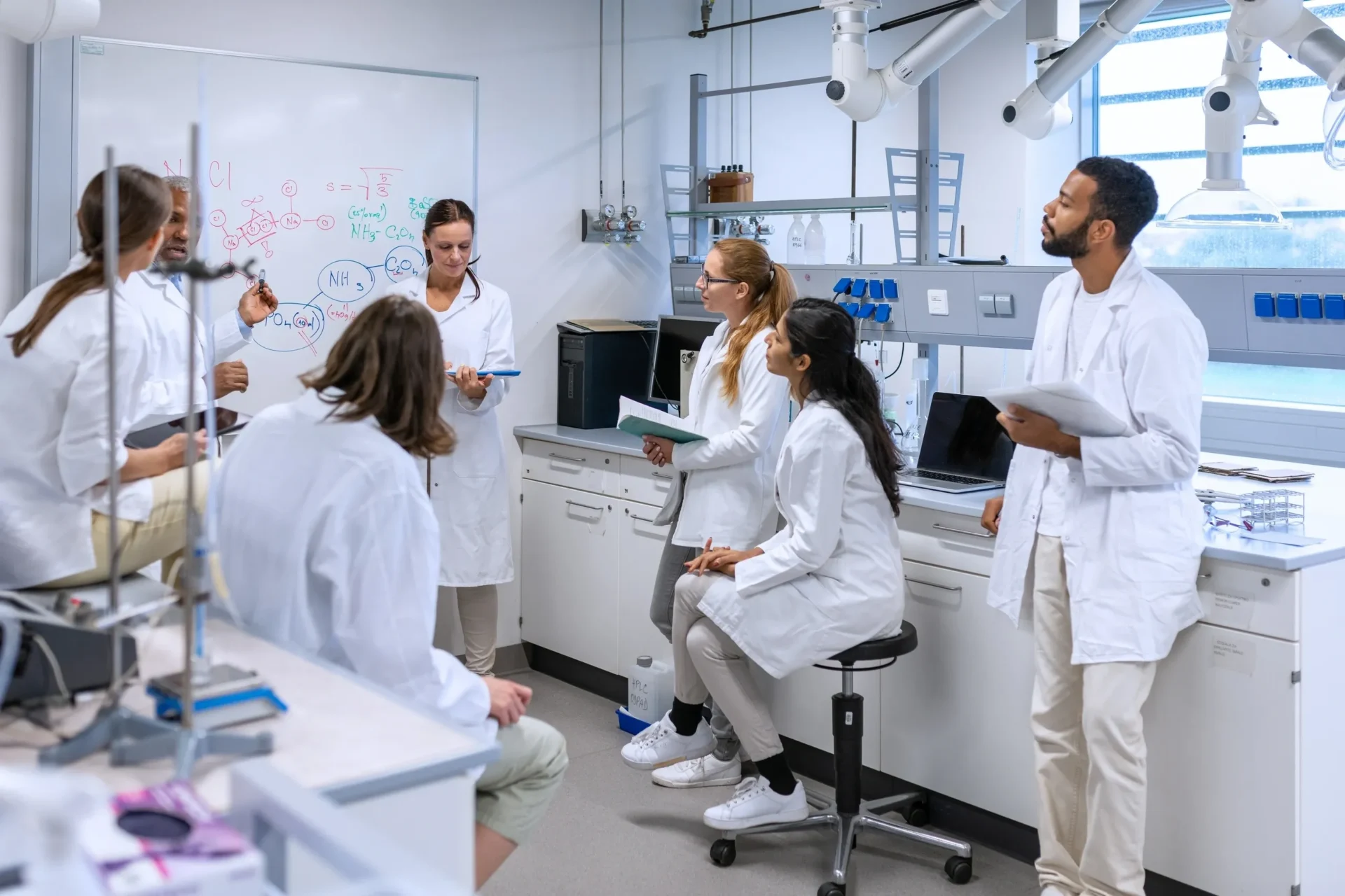 Group of researchers collaborating in lab coats