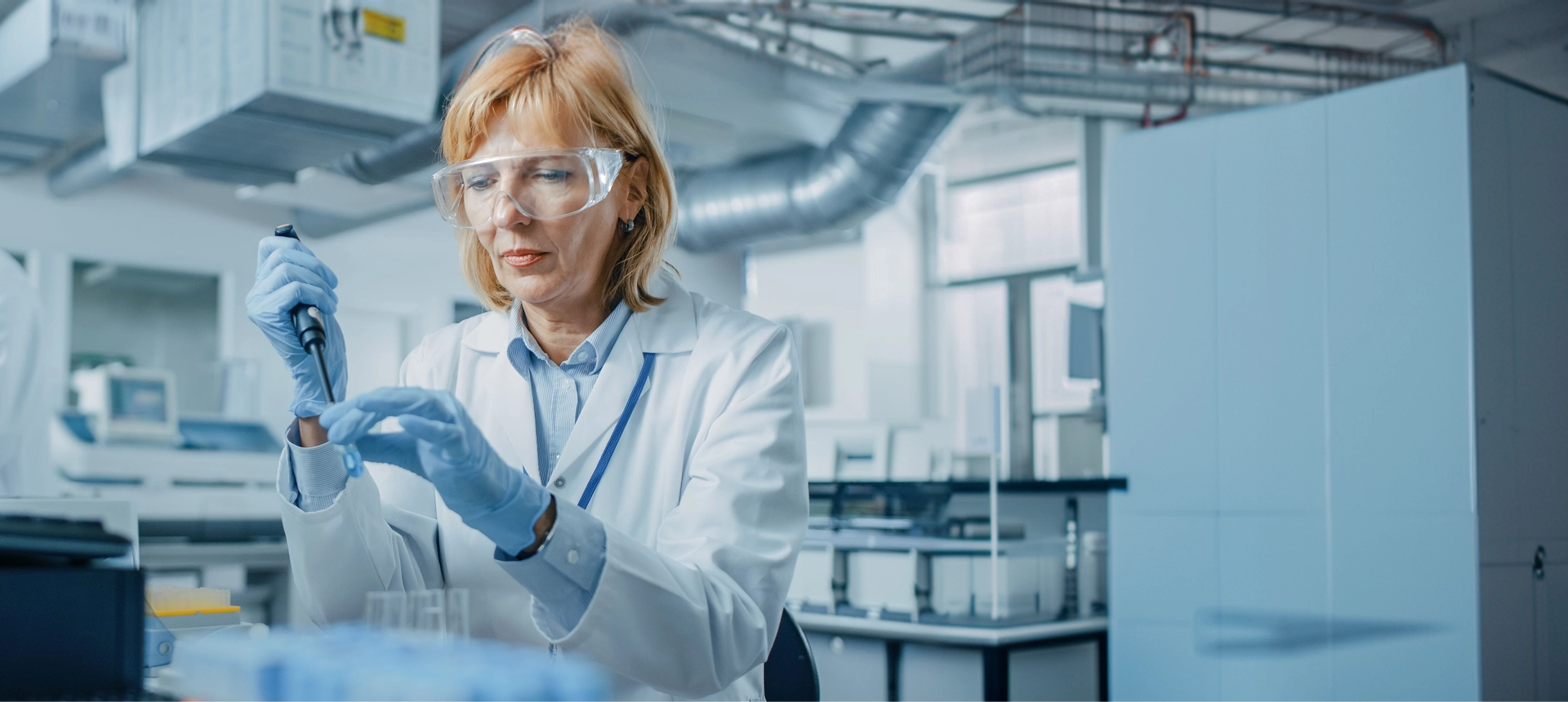 Scientist working in a laboratory wearing safety glasses.
